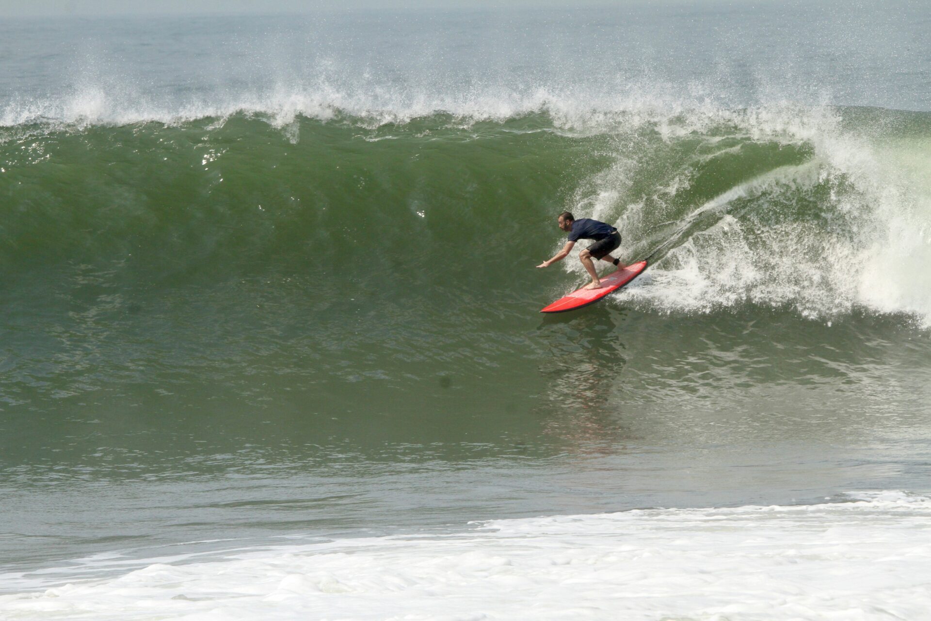 A person on a surfboard riding a wave.